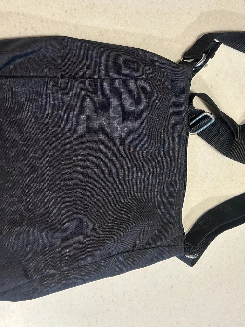 baggallini Pocket Town Crossbody bag in the black cheetah embossed pattern